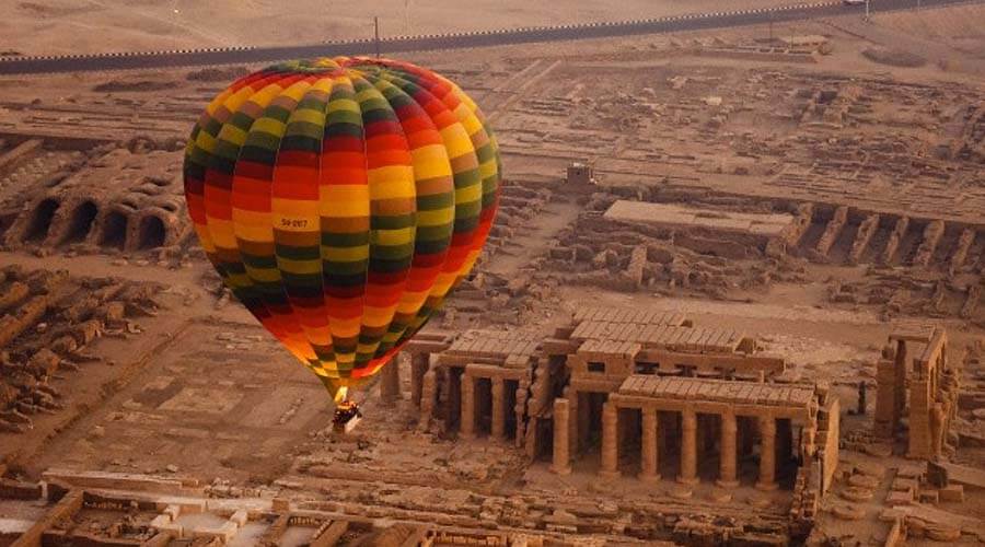 A hot air balloon is seen flying over a city